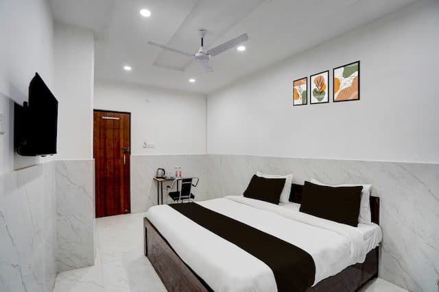 Guest room with a double bed and framed wall art