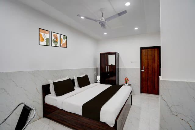 Bright guest room with a double bed and wall art