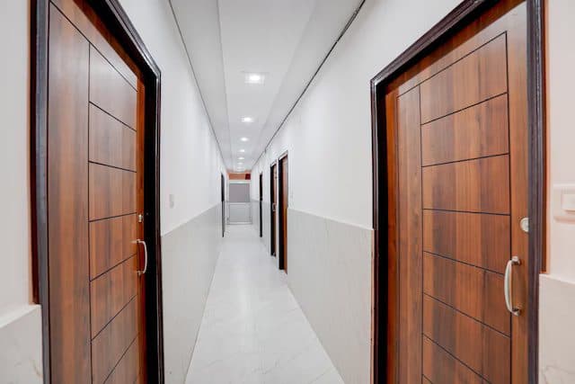 Clean interior corridor with polished wooden room doors