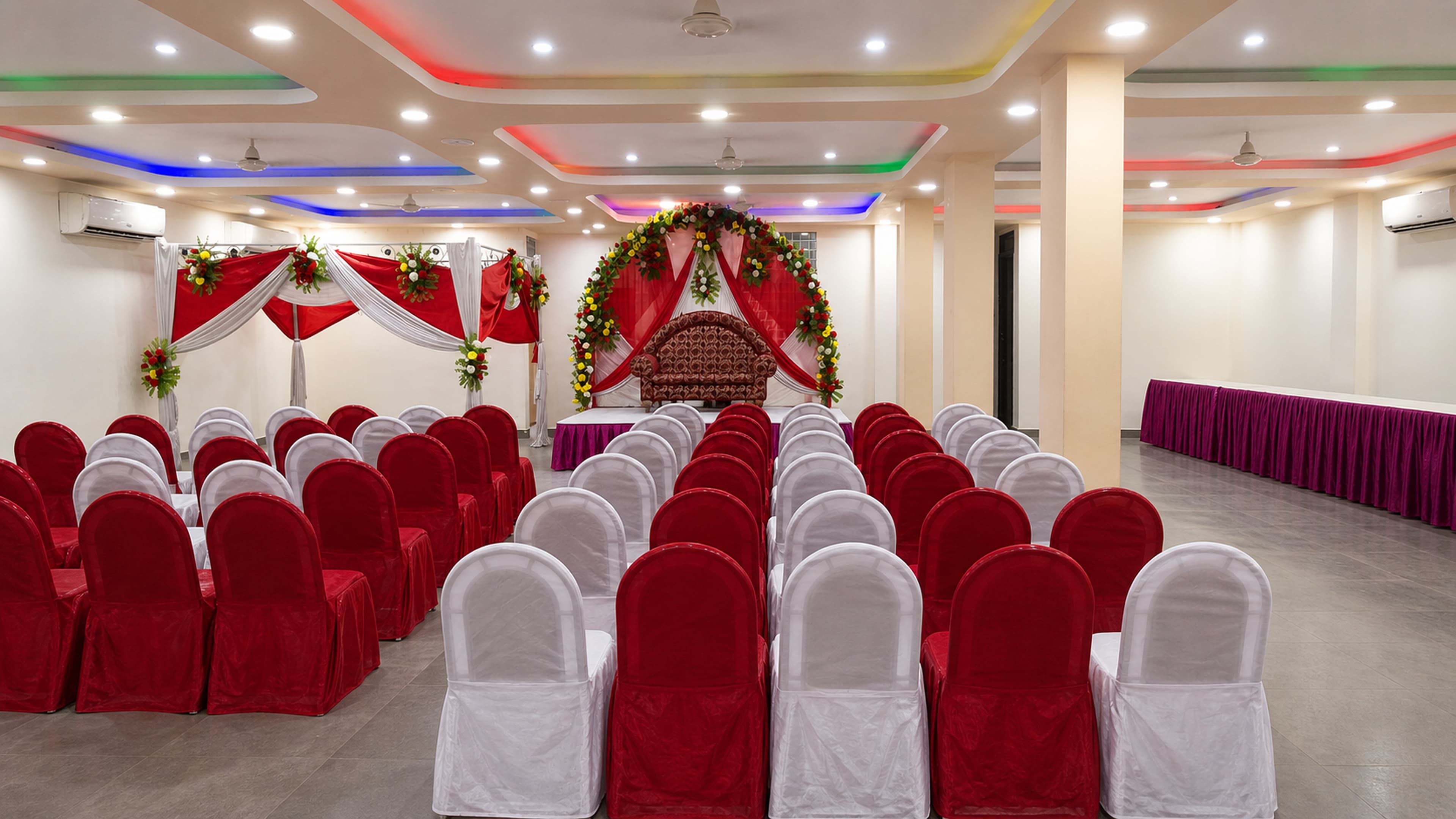 Floral stage and seating set up in the air-conditioned hall