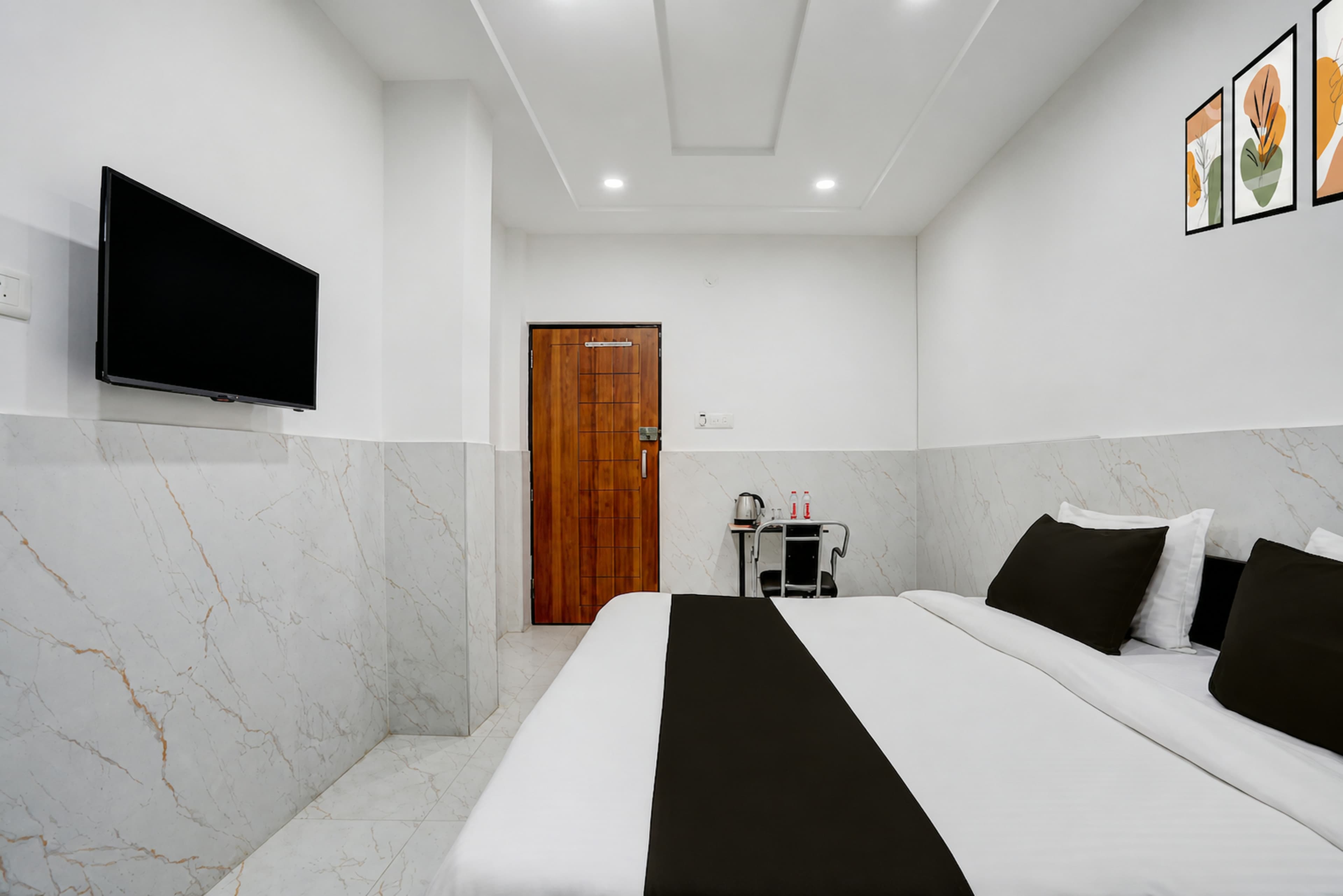 Bright, clean AC guest room with a made-up double bed at Metro Club & Guest House, Lucknow