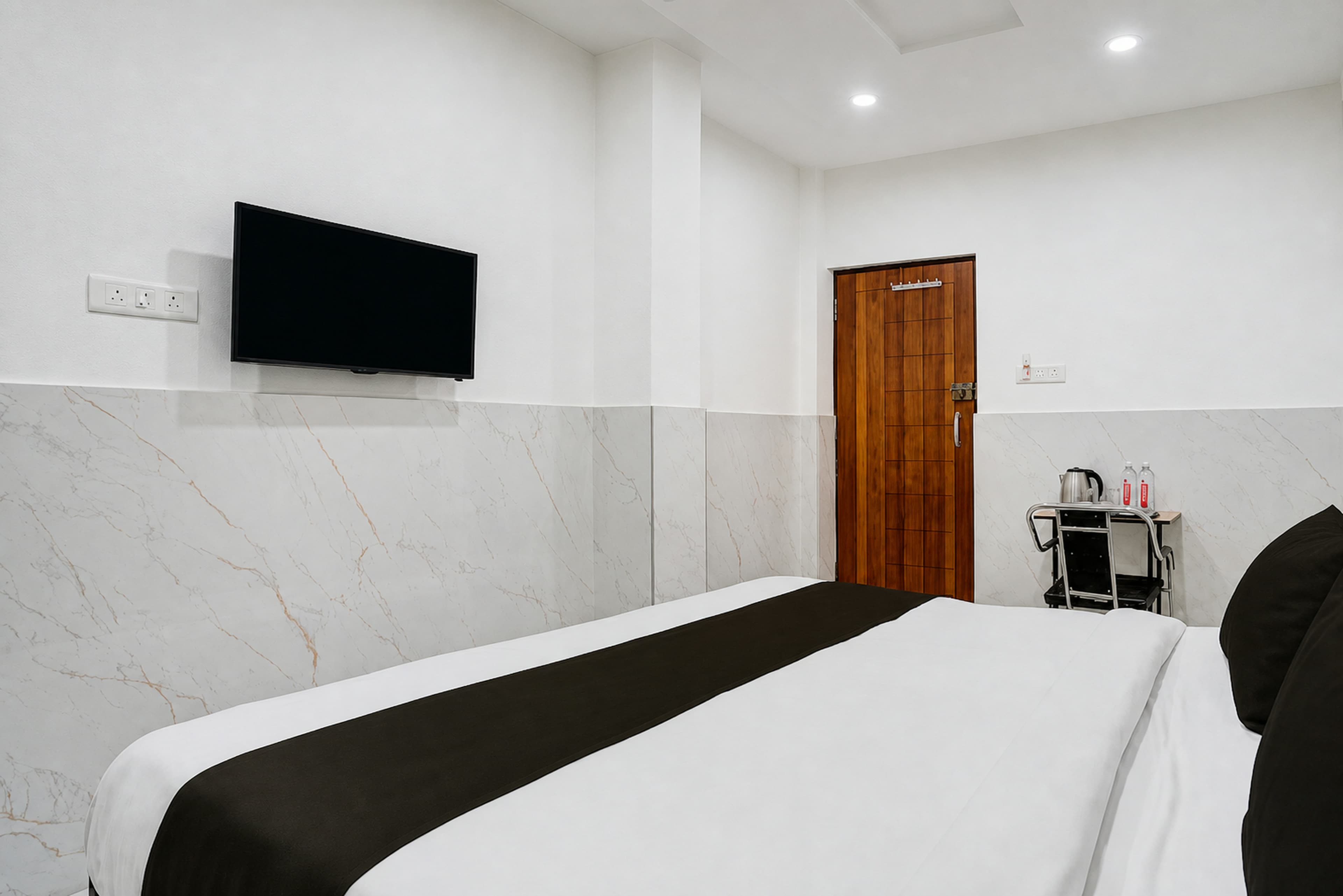 Guest room with a made-up bed and tiled flooring